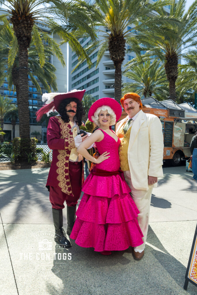 Cosplayers portray Captain Hook from 'Peter Pan', and Charlotte and 'Big Daddy' La Bouff from 'The Princess and the Frog', posing for a portrait during Wondercon 2025.