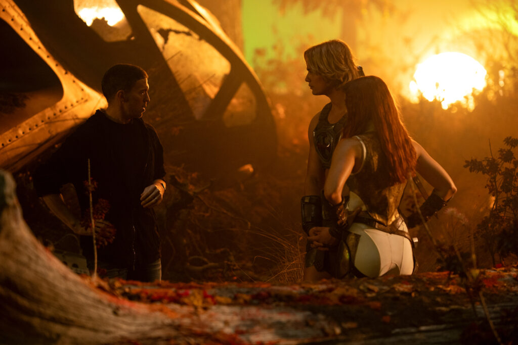 Director Travis Knight, Nicholas Galitzine, and Camila Mendes on the set of Masters of the Universe.